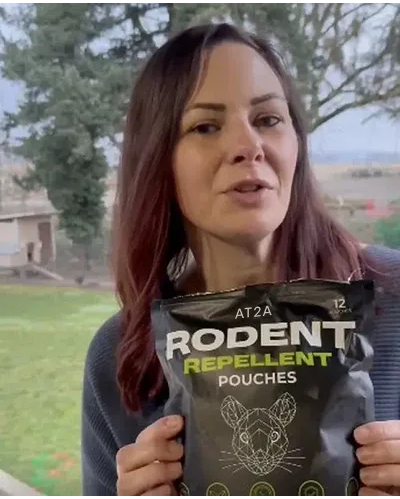 Customer holding AT2A rodent repellent, photo 3