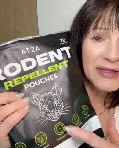 Customer holding AT2A rodent repellent, photo 1