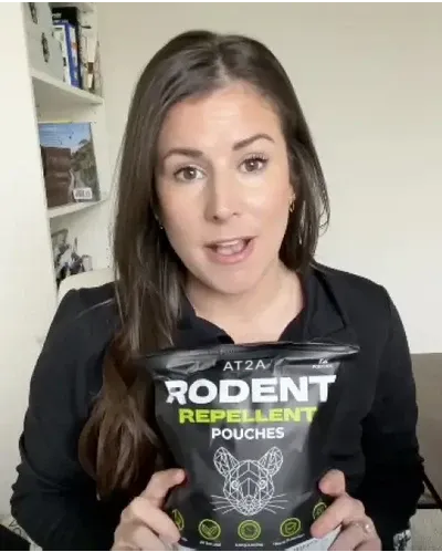 Customer holding AT2A rodent repellent, photo 2